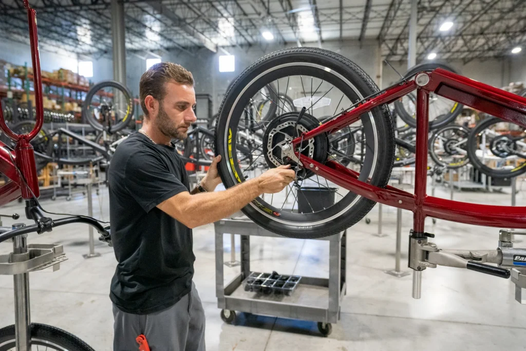 Life Ev Worker is building a e-bike inside a warehouse. 